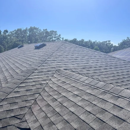 Side‑profile view of a newly completed roof replacement on a Manatee County home, highlighting uniform shingle lines and upgraded drip edge.